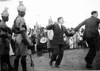 "Some of the lads having a 'fling' at the Palamo fair to the pipes & drums of the Indian Highlanders. Les."